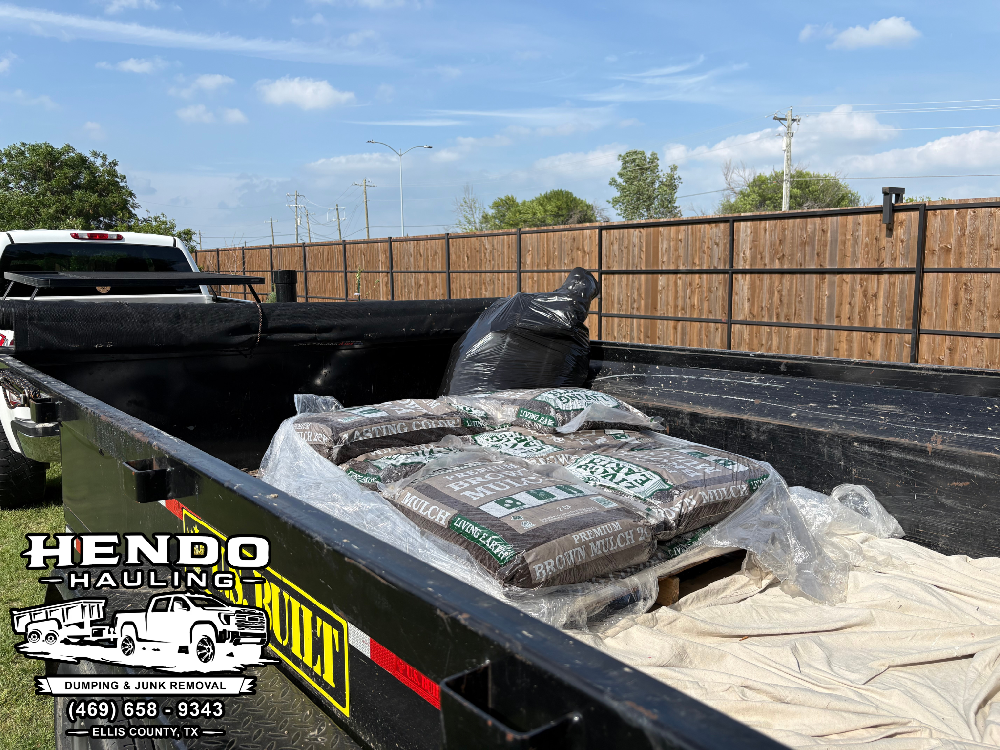 Hendo Hauling trailer load with mulch and junk removal work